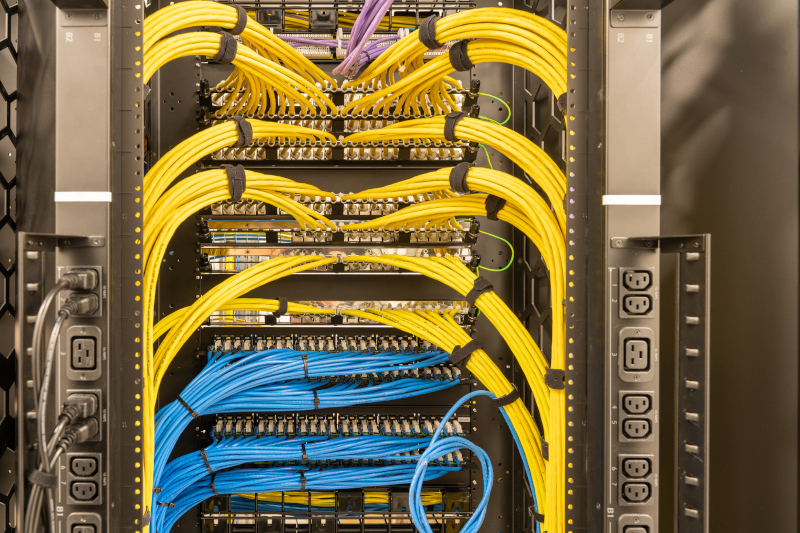 Tidy patched network cables, RJ45, connected to the switches and routers, data centre Low Voltage Systems Cabling